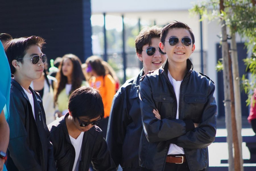 Greaser stands, smiling after finding out that him and his clan won the costume contest. 