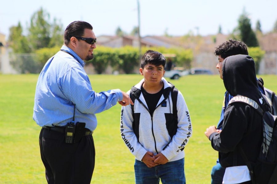 Assistant principal, Carlos Saucedo, tells a group of freshman to leave the field during a walk-out, while he had told others if they were on the field that they couldnt leave. 
