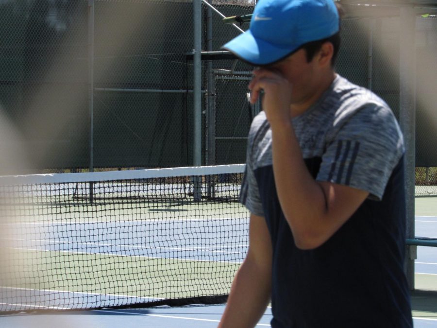 Senior Eduardo Rosario lowers his head, almost in defeat, of opposing team Francis Parker. They would go on to lose the match with a final score of 6-2.