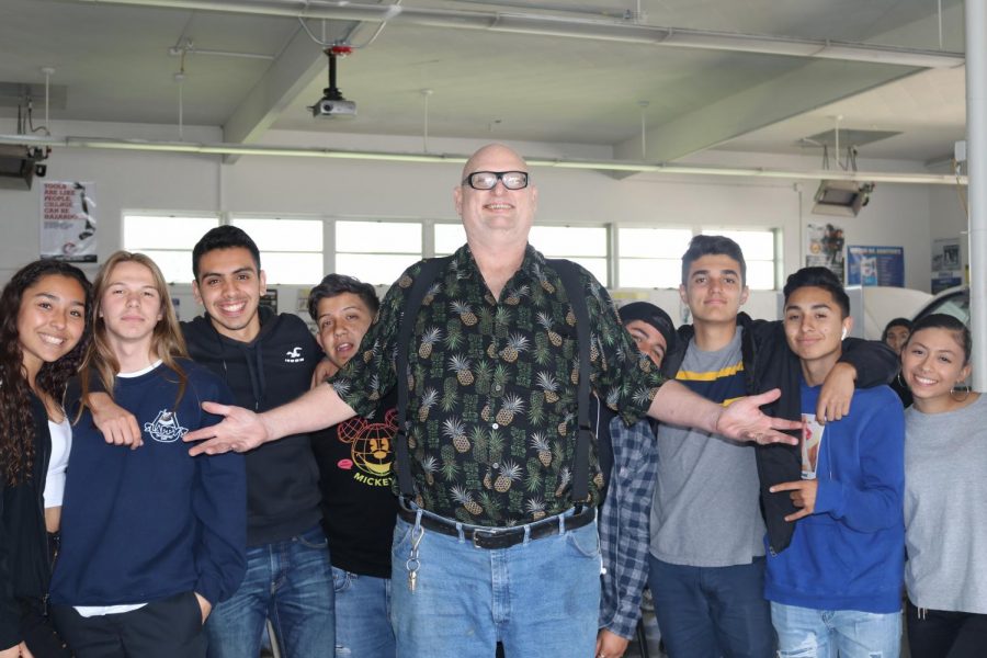 Ben Hazel poses with his sixth period students during his final days teaching at Bonita Vista High. He prepared the auto shop for the next teacher to take over.