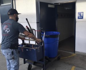 Custodian Sergio Mirmolejo enters the 500s building boys bathroom on Monday, Dec. 2. He cleans this bathroom almost everyday after school and often is faced with a heavier workload when having to fix appliances that have been vandalized or broken by students.