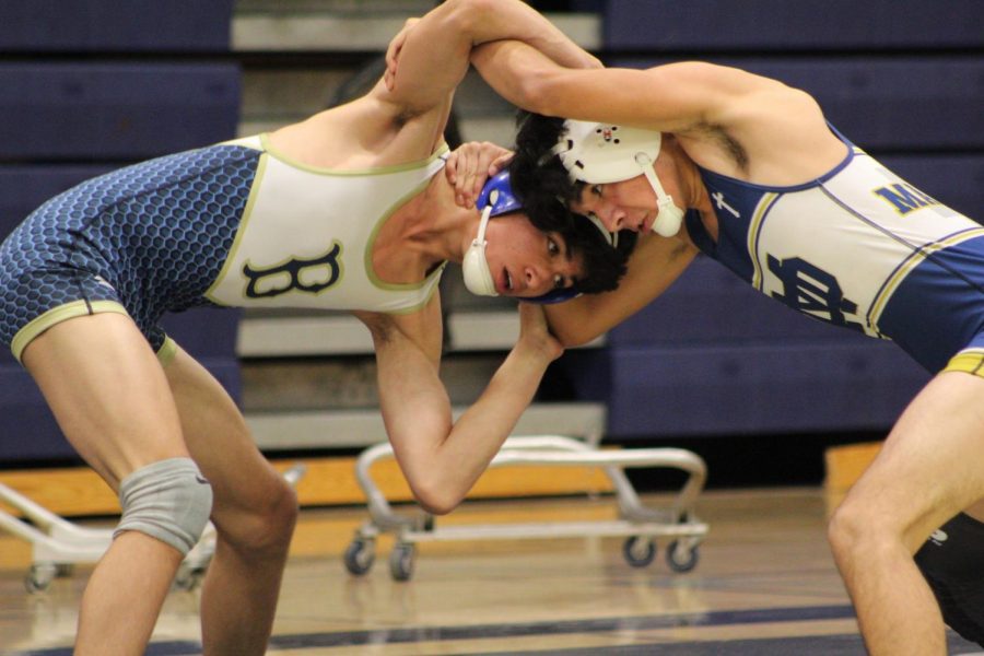 Junior Ricardo Castillo buds heads with an opponent from Mater Dei during one of the many matches on Dec. 12th. The match ended with the
Barons taking the win with a score of 66-10.