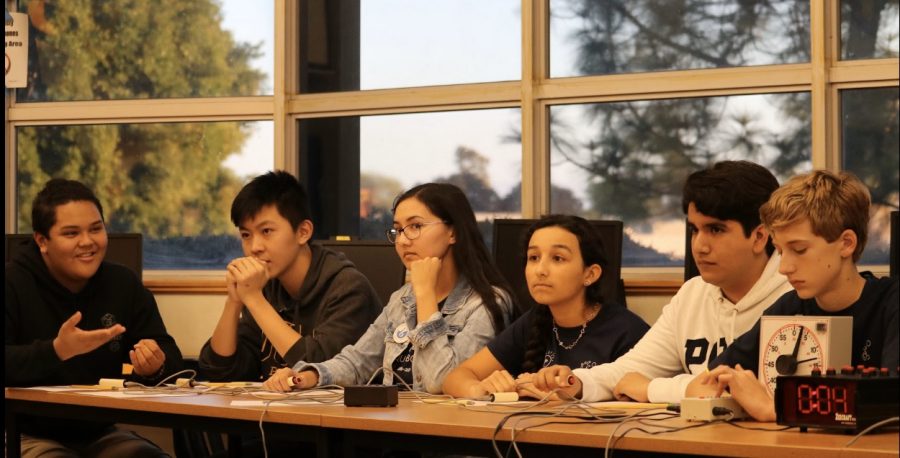 Varsity Quiz Bowl members (left to right) senior AjaniOquendo, sophomore Henry Tang, junior Ursula Neuner, junior Lucía Rivera and junior Gerardo Gonzalez hold their buzzers during the match. At this point, their opponents were several hundred points ahead.