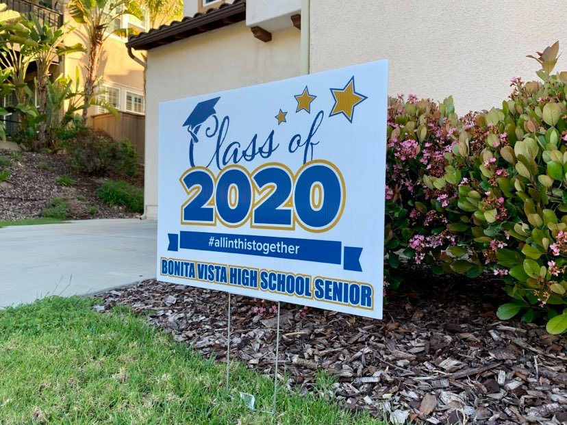 In Chula Vista, a front lawn is adorned by a sign that reads Class of 2020 #allinthistogether Bonita Vista High School Senior. Many seniors in San Diego County have purchased these signs from different sources in order to celebrate their graduation from high school.