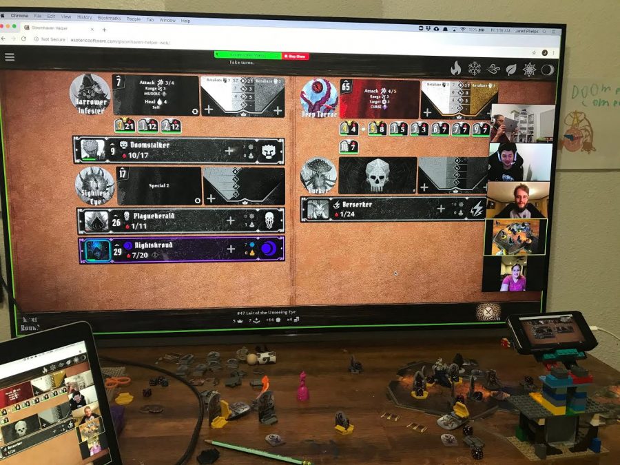 IB Coordinator Jared Phelps takes a photo of gameplay from strategy-based board game Gloomhaven. Phelps and other teachers participate in online game sessions roughly every month.
