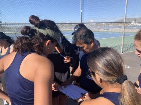 Left to right: Bonita Vista High (BVH) girls tennis captain, Number Two Doubles player and senior Bibiana Martinez, BVH girls tennis coach Joseph Sheffield and Number One Doubles Player and sophomore Paola Nirmal are huddling together before the match. They are discussing what positions they will play, a decision that ultimately determined the outcome of the game.