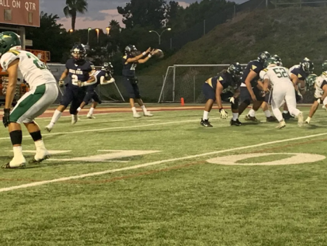 With the snap of the ball the Barons started an offensive play during their homecoming game. The Barons lost with a score of 0-47.