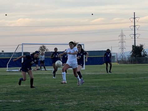 Middle forward and junior Luna Beaulieu (10) and forward and junior Jenica Stell (12) try to defend the ball from Mater Dei player. Beaulieu would run and kick the ball before the Mater Dei player.