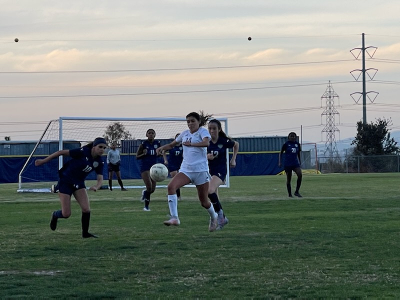 Middle forward and junior Luna Beaulieu (10) and forward and junior Jenica Stell (12) try to defend the ball from Mater Dei player. Beaulieu would run and kick the ball before the Mater Dei player.