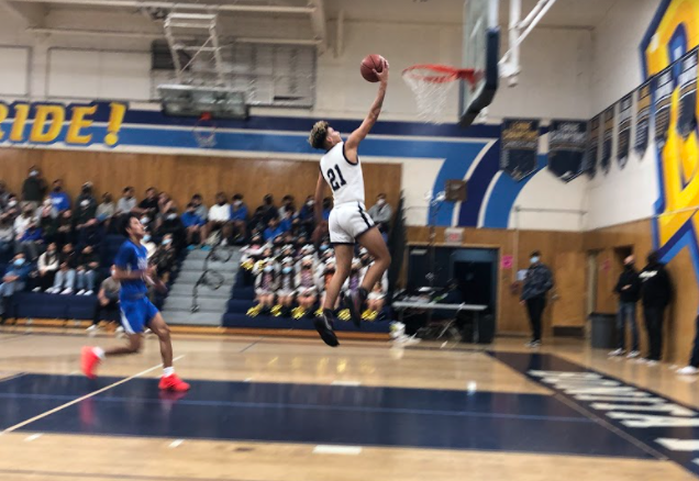 During Bonita Vista Highs game versus Eastlake High, guard and forward junior Mikeal Pink dribbles across the court, running through player after player so that he can get to the hoop. Once he does, he jumps for a lay-up.
