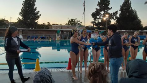 As Girls Water Polo Coach Betty Alexander reads the names of members on the team, senior and Set Yarenni Hernandez (15) receives flowers before the Senior Night game on Feb. 3, 2022. After the Junior Varsity (JV) game took place, Alexander had the seniors on the JV team play on the varsity team.