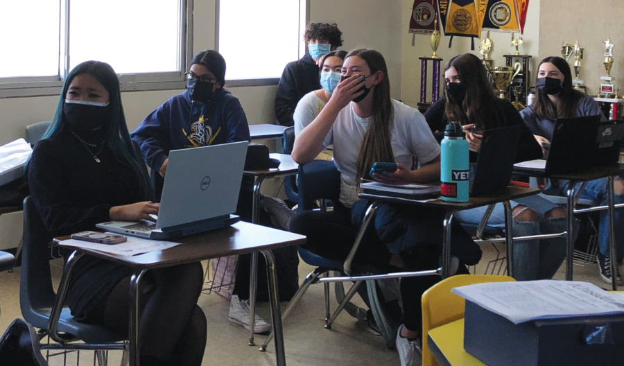 On Feb. 4, in room 703, students watch the virtual assembly from their desks. Students eyes widen as they gasp at the girls water polo victory.