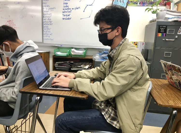 Senior Pablo Shimizu completes work for his third period International Baccalaureate (IB) Spanish HL class. The work entailed reading a section of the course textbook and answering two questions, after completing the assignment students were free to work on other classwork.