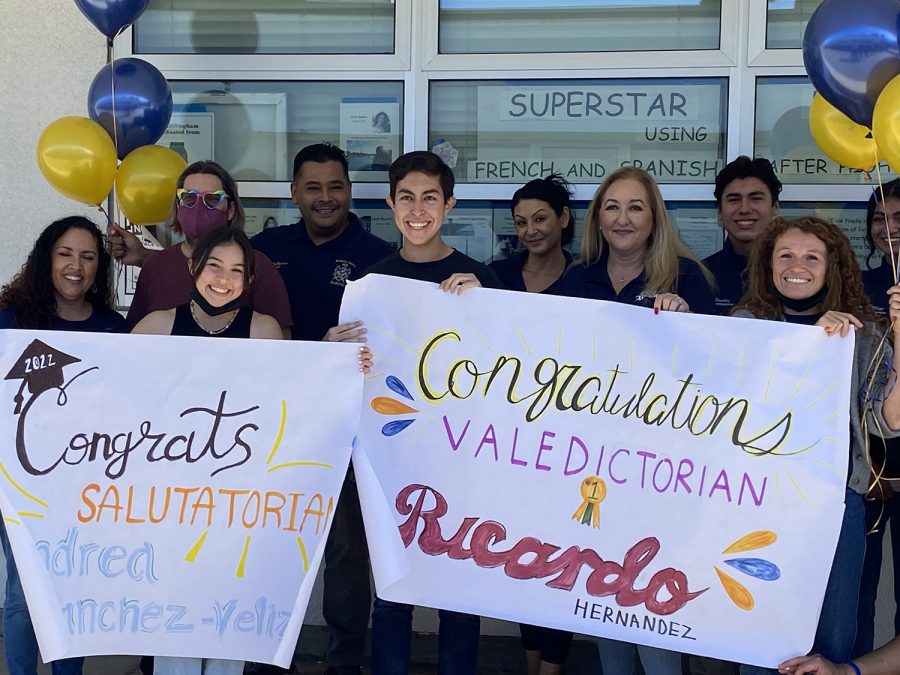 Seniors Andrea Sanchez-Veliz and Ricardo Hernandez carry their Salutatorian and Valedictorian posters. BVH Principal Roman Del Rosario Ed.D. made the announcement in their third period IB Spanish class.