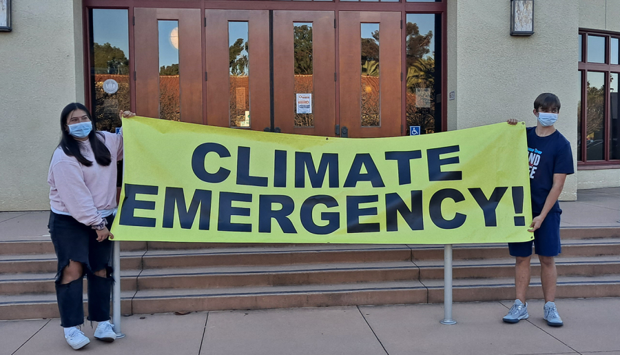 Hilltop High freshmen and Youth 4 Sustainability members Faith Avila and Eric Boyels display a poster and pose for photos to promote the Climate Emergency Declaration event at Chula Vista City Hall. Both Avila and Boyels later spoke during the meeting to urge council members to approve the act.
