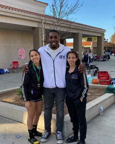After a long day of wrestling, the two BVH girl wrestlers, senior Kanoe Lopez-Griggs (left) and sophomore Tiana Alanis (right), celebrate their achievments with their coach, professional wrestler Phil Davis. Lopez-Griggs won third and qualifies for Masters, and Alanis won fifth, just short of qualifying. 