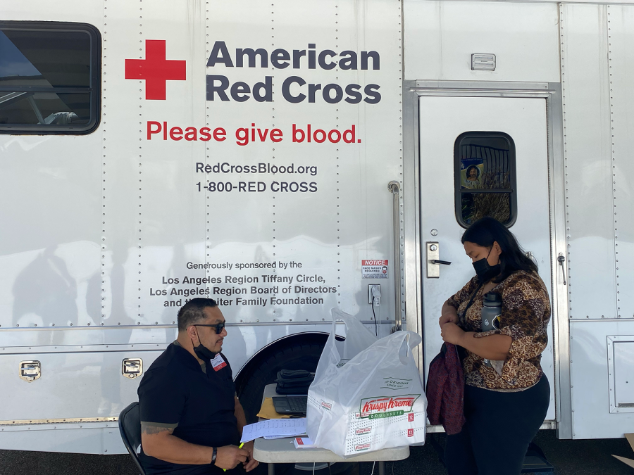 On April 15 in the Bonita Vista High (BVH) south parking lot, Red Cross volunteer Santos Muniz assists junior Arianna Cruz check in for her blood donation. Before donating blood, donors must fill out a RapidPass health history questionnaire. 