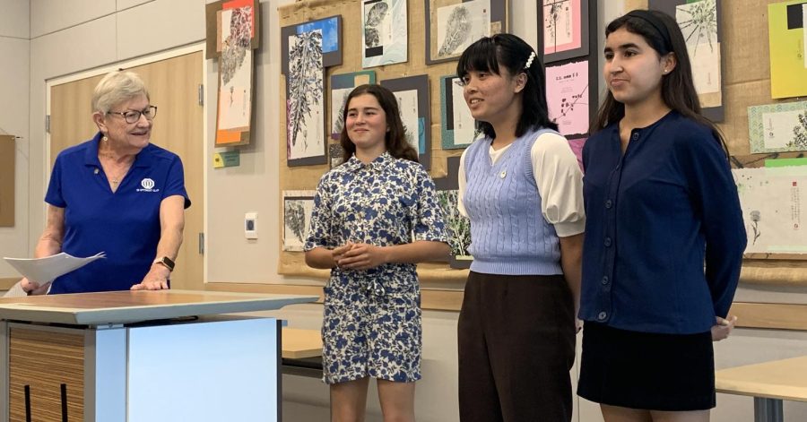 Treasurer of the Imperial Beach Optimist Club and Lieutenant Governor of Zone two, Virginia Syverson (left) announces the placement for each student speaker. Contestants and juniors Eiffel Sunga (middle right) and Giselle Geering (far right), stand in anticipation to hear what they were ranked.