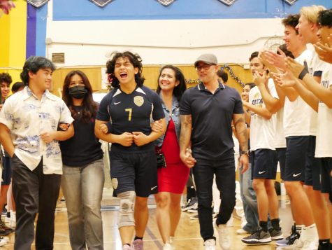 Senior Captain and Setter for the Bonita Vista High (BVH) boys volleyball team John Delara walks onto the court with a line of players and friends cheering him on. They all cheer for him as they celebrate his last year on the team in style.