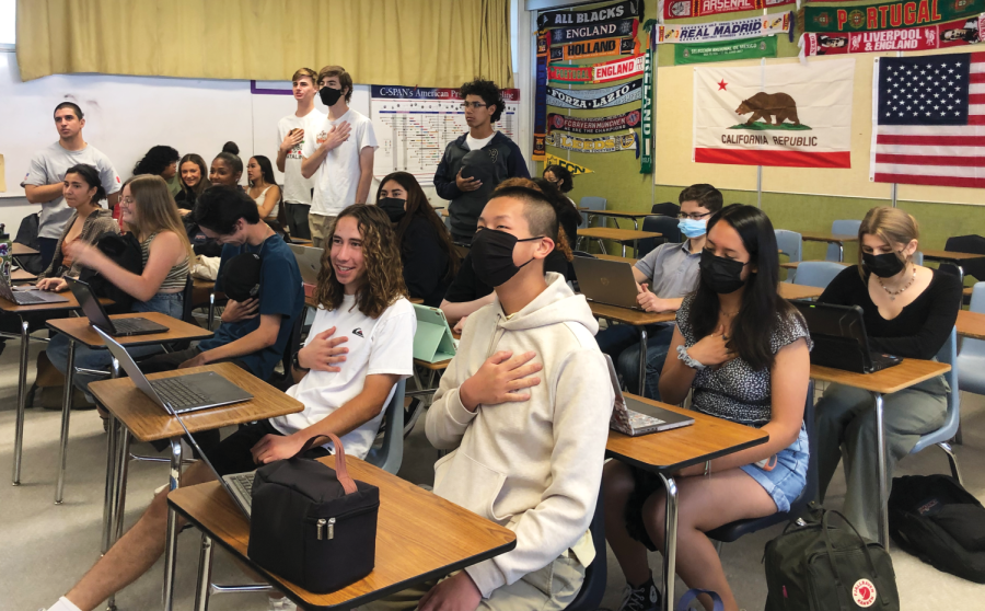  Four students in Mathew Lambert’s second period AP Government class stand to recite the pledge of allegiance. The rest of the class chooses to remain seating during the pledge.