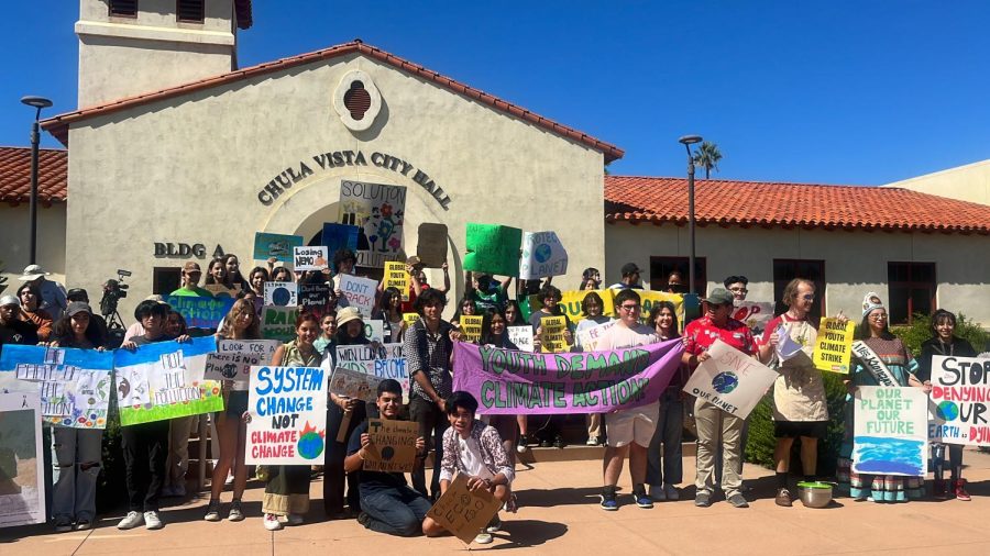 The Southbay community lines up at their last stop—front of the Chula Vista City Hall—to take a photo of their annual climate rally. While taking photos, multiple chants like What do we want? Climate justice! When do we want it? Now! could be heard.