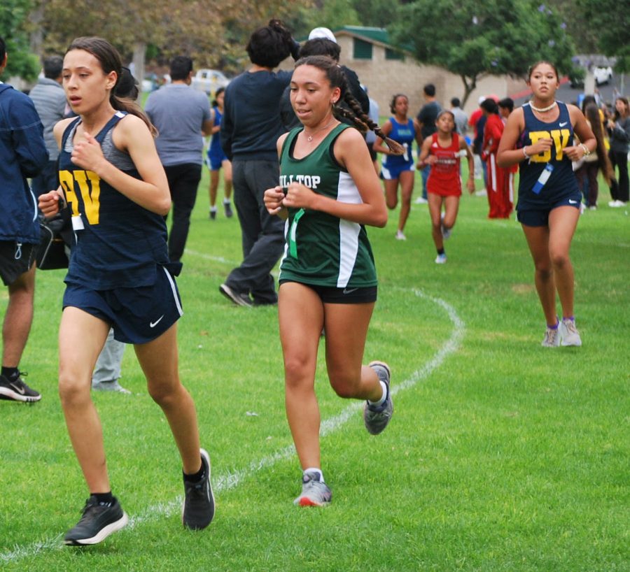 BVH girls’ cross country runs at their meet against Eastlake High School in Rohr Park on Oct. 14 . Renee Khuong out runs Hilltop, while Olympia Jara catches up.