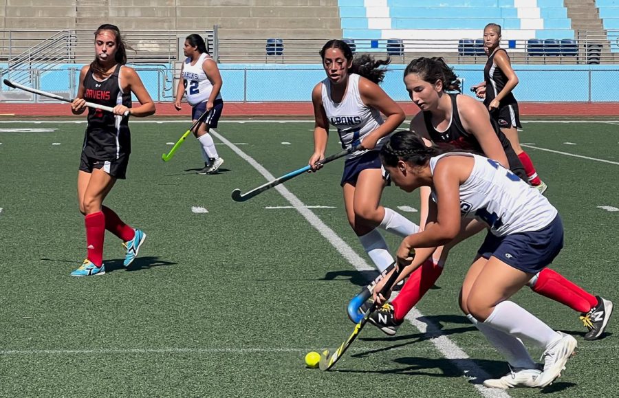 BVH left forward and sophomore Brianna Gutierrez (34) fights for possession of the ball as BVH top diamond defender and freshman Natalia Gil (17) rushes to support her. They make their way toward the Ravens goal.