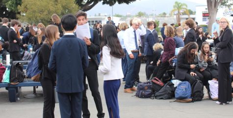 Different student debaters from different schools gather in the BVH quad between rounds. Some prepare for their next debate, others choose to relax and converse with peers.