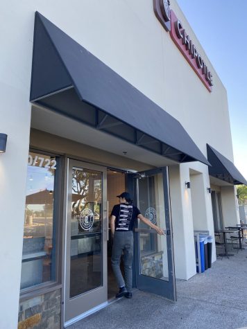 Student worker and senior Angel Rodriguez walks into his 5 oclock shift on Sunday at the Chipotle in the Bonita Point Plaza.