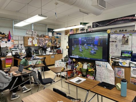 International Baccalaureate Environmental Systems and Societies (IB ESS) teacher Jennifer Ekstein projects a livestream of the FIFA World Cup on her large monitor for her second period IB ESS class. The livestream plays as students do individual group work.