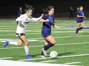 On Jan. 17. Bonita Vista High (BVH) Girls’ varsity soccer team played an aggressive and intense game against Olympian High School (OHS). In the second half, BVH junior and forward (6) Katelyn Romo takes the ball up the field as OHS sophmore and midfielder (42) Kirsten Licon trails her.
