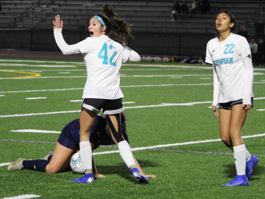 Licon grabs Romo by the shoulder and brings her to the ground. As the referee calls for a foul, Licon and OHS junior and fullback Gabriela Venegas (22) argue the call. Romo begins to get up from the foul as Licon claims that it was all ball!