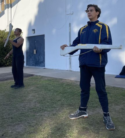 Color Guard captain and senior Jayden Zwolinski and Color Guard member Cesar Armenta practice outside the band room at BVH. Practices become more rigorous as the winter season nears. 