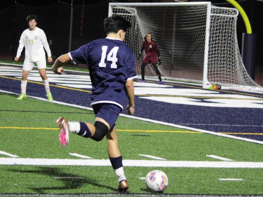 Senior Hugo Enriquez (14) takes a shot towards goal in the first half of the game. The BVH boys soccer team wins the home game with a 4-1 score, continuing their 7-0 winning streak and solidifying themselves as league champs.
