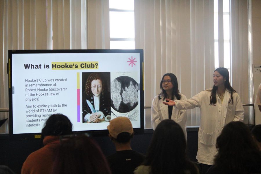 In the Bonita VIsta High (cafeteria) Public Relations Officer and junior Brianna Magtoto stands by Vice President Vivian Nguyen as she explains the origin of the Hookes club. This presentation was given beforehand to give students and parents an idea of the club and what will be happening.