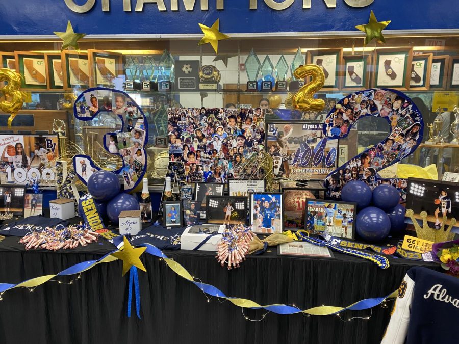In the front of the gymnasium as the audience walks in, they can see decorations for the varsity seniors. These decorations consisted of pictures from the athletes as they were younger to show how much they have grown during their basketball career.