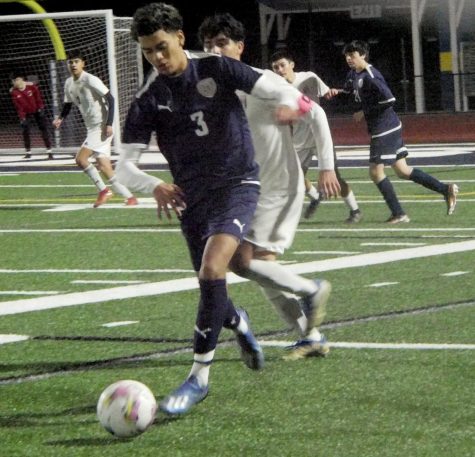 On Jan. 19 at Bonita Vista High (BVH) midfielder and senior (3)  Ulises Palafox is ready to pass to another BVH teammate against Castle Park in the first quarter. The team scored was 5-0 on a rainy and cloudy night.