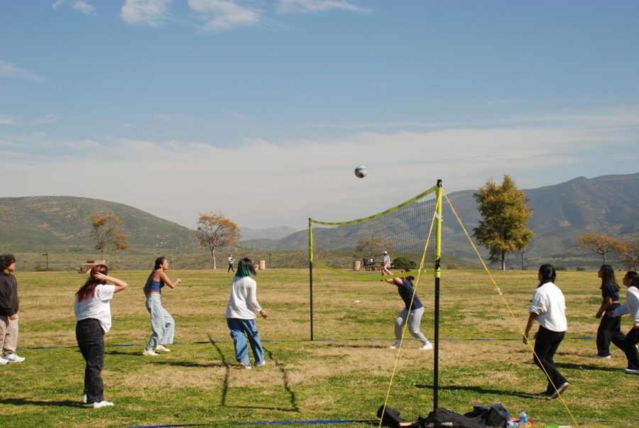 Members from two different schools that attended the PAYO Friendship Games join together to play a game of volleyball. There were several sport activities at the event. 