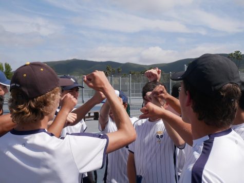 The boys varsity tennis team chants  before officially starting the California Interscholastic Federation (CIF) game taking place at San Marcos High. The team then disperses to the courts for the matches to begin at 3:30.