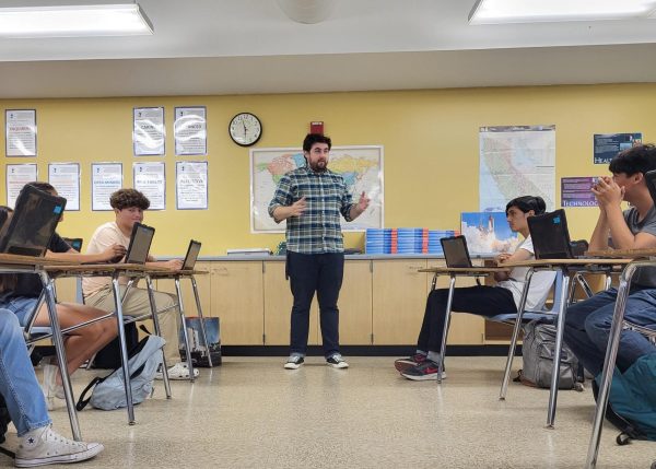 World Geography and IB DP Seminar Core teacher Cody Bett in charge of multiple clubs on campus including Quiz Bowl. He is seen teaching one of his geography classes.