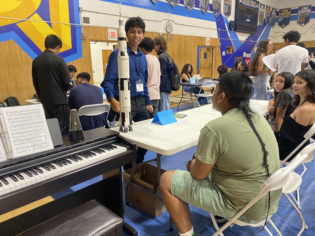 On Sept. 21, International Baccalaureate (IB) seniors present to IB juniors with a prompt and three real life props to represent what their prompt means.  IB Diploma candidate and senior Manuel Jurado uses a piano, a LEGO rocket ship and a physical copy of the movie Under the Same Moon.