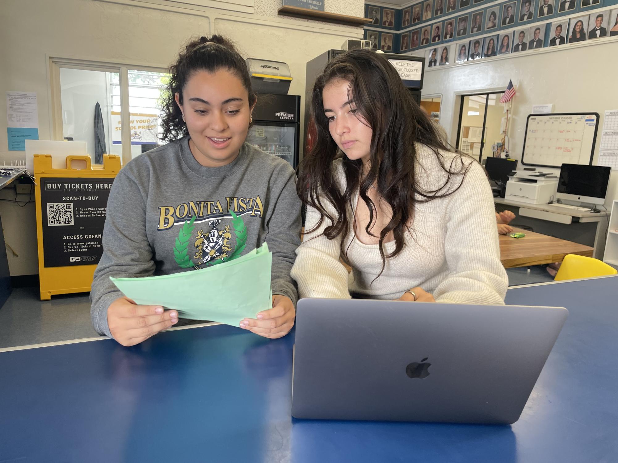 Senior and ASB president Alexis Acosta looks over ASB documents with senior and ASB member Aryanna Baca. Acosta and Baca have been friends since elementary school. 