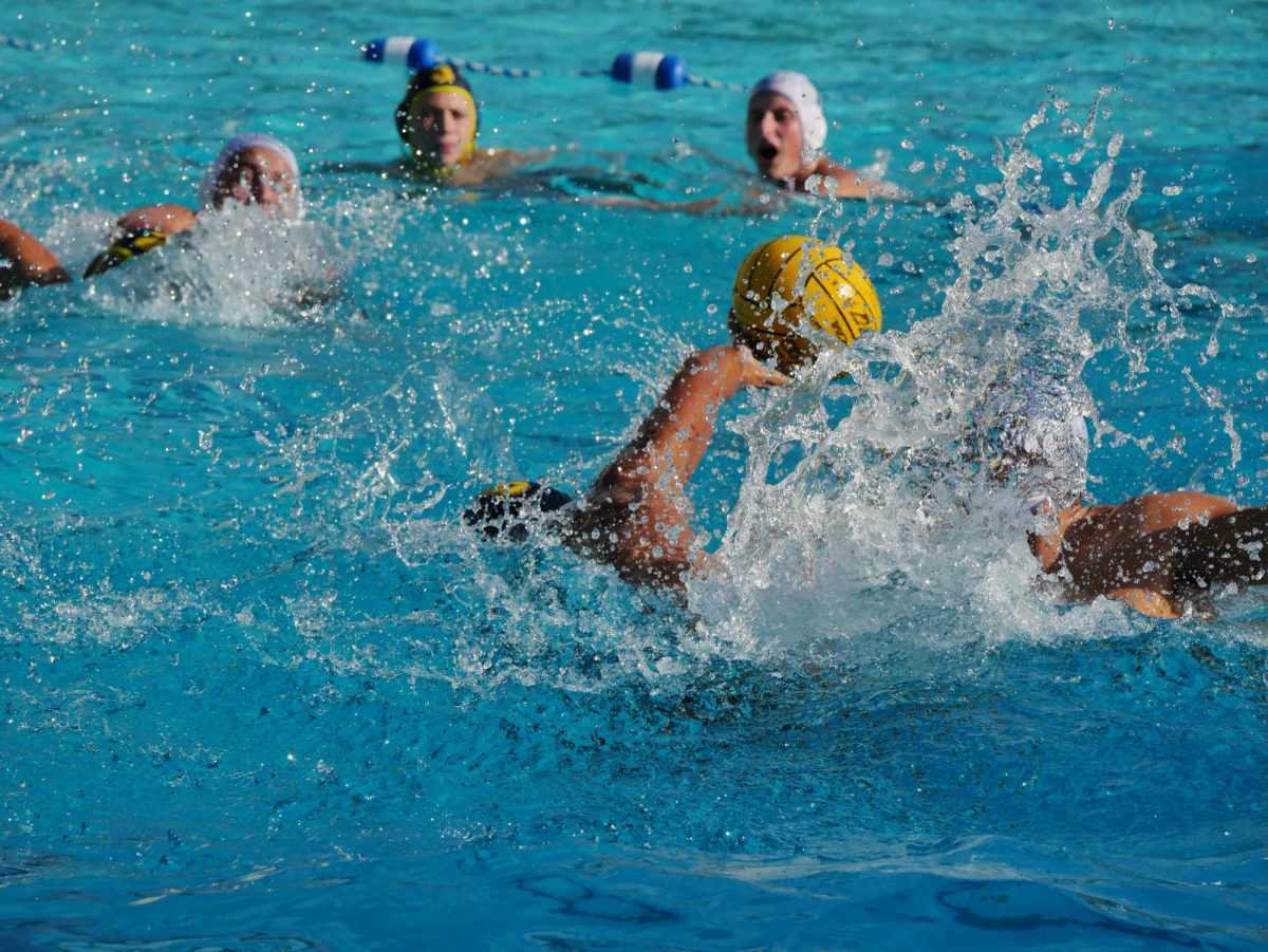 On Oct.12 the Bonita Vista High (BVH) Boys Water Polo played a league game against their rivals, Eastlake High School (EHS) at Parkway Aquatics Center. BVH Captain and junior Trevor Manaligod palms the ball as he turns an EHS field player to open up a path towards the cage for himself.