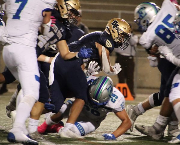 On Oct. 27, the Bonita Vista High (BVH) varsity football team contested Eastlake High (EHS) at home on the Barons senior night. BVH running back and senior Carlos Ochoa (21) runs the ball and powers through multiple EHS players as he tries to get his team a first down.
