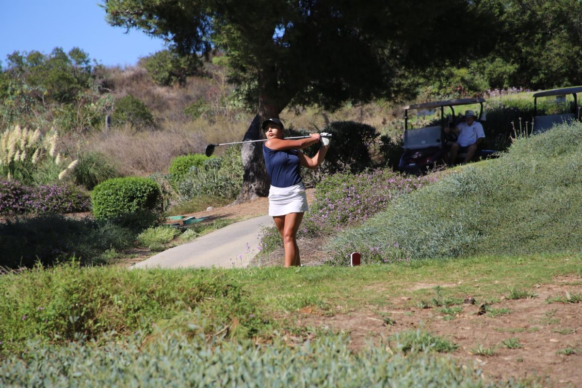 On Oct. 10, the Bonita Vista High (BVH) varsity girls golf team lost to the Torrey Pines High Falcons in their first round of postseason playoffs. BVH sophomore Leilani Mena is shown driving the golf ball down the course as a means to progress the match. (Provided by Alexis Acosta)
