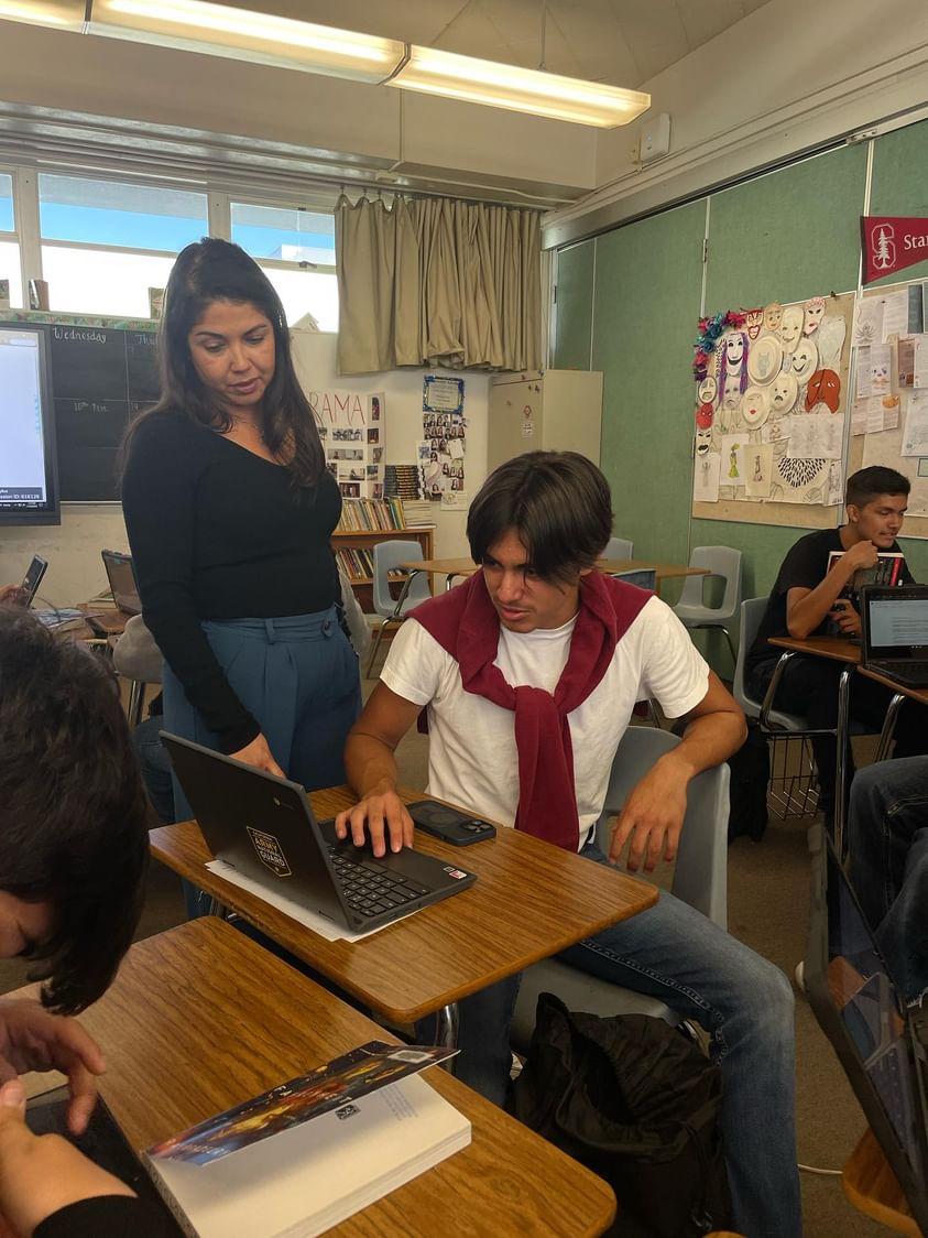 On November 27, 2023, Mrs. Sias moves around her classroom working with her students on various assignments. Mrs. Sias is the new IB theater teacher and happily embraces her role.