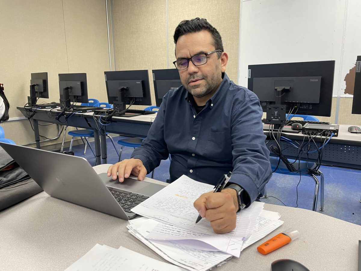 Former newspaper advisor and current Yearbook advisor Juan Garcia is seen grading for his fifth period yearbook class. Garcia advises for yearbook so as to continue his passion for teaching a form of journalism.