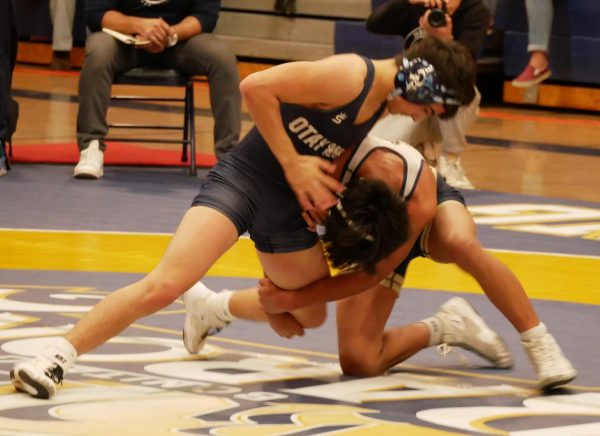 Bonita Vista High (BVH) sophomore and 126 pound wrestler Ivan Hernandez attacks his opponents leg in the hopes of getting a takedown. Hernandez would win his macth via points and add to BVHs growing score against Otay Ranch High.