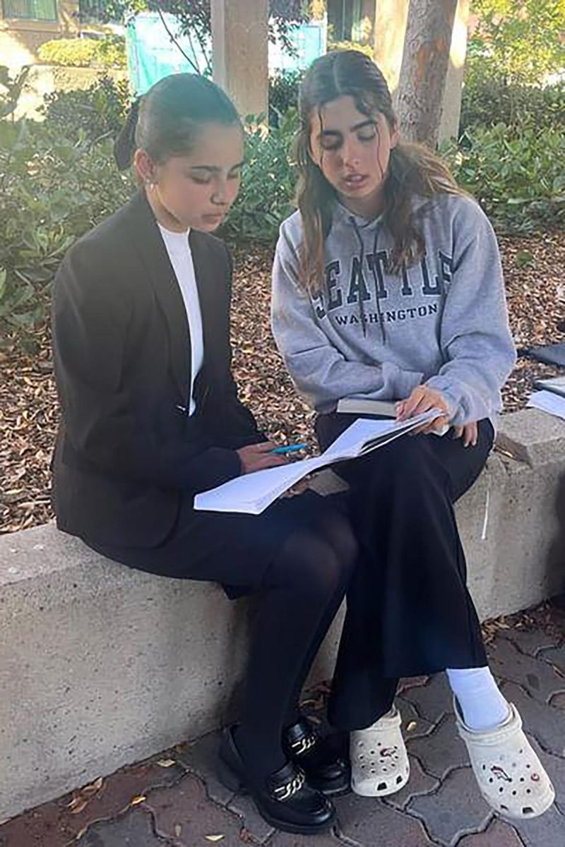 On+Dec.+3%2C+freshmen+Viviana+Blanco+%28left%29+and+Elizabeth+Hoffman+%28right%29+reflect+on+the+debate+rounds+they+have+participated+in+at+a+speech+and+debate+tournament.+Debate+is+one+of+the+many+extracurriculars+of+fictional+character+Rory+Gilmore+from+the+show+Gilmore+Girls.+This+is+why+Blanco+and+Hoffman+are+among+the+many+teenage+girls+who+idolize+Rory+Gilmore.+
