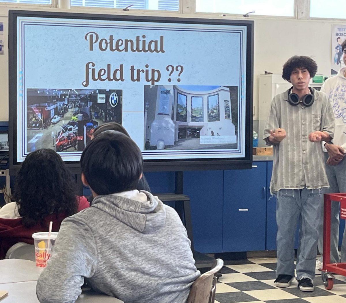 On Jan. 29, Bonita Vista High (BVH) Car Culture Club co-president and senior Haydn Lopez gives a slideshow presentation about Car Culture Club at the clubs first meeting during lunch at BVH autoshop. Lopez is informing the clubs members of a potential club field trip to the San Diego Automotive Museum. This topic was among other informational slides about the Car Culture Clubs plans for this year, such as participating in BVHs food fair to raise money.